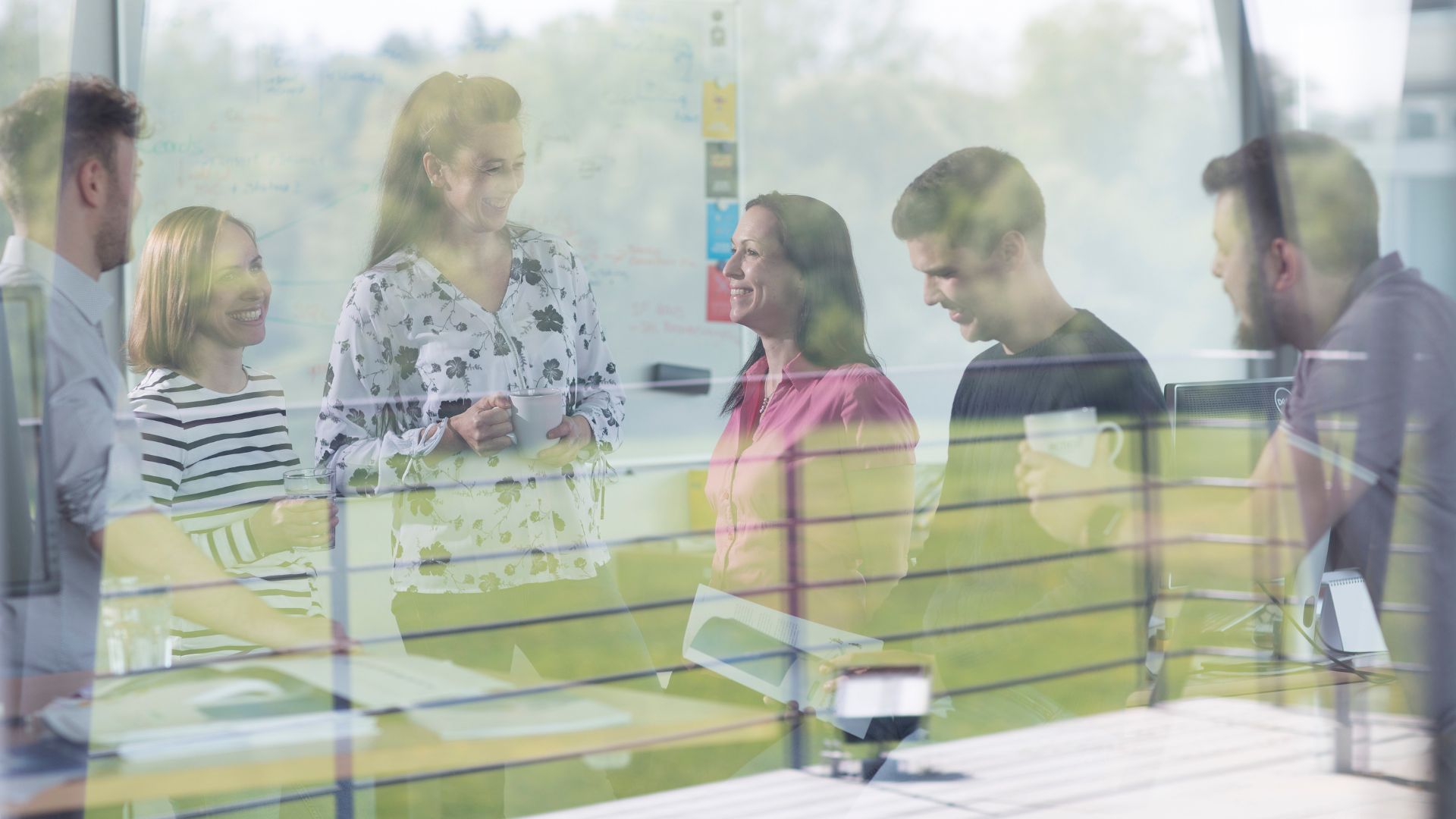 ACTICO keyvisual group of people behind a window