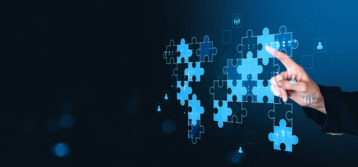 Hand,Placing,Puzzle,Pieces,Forming,A,Glowing,Digital,World,Map,